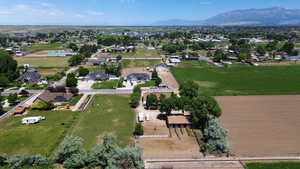 Aerial view of property and surrounding area featuring a mountain backdrop