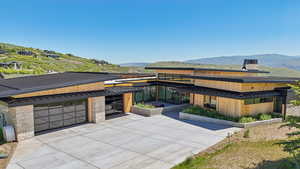 View of front of property featuring a standing seam roof, a mountain view, and metal roof