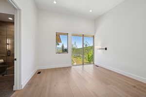 Unfurnished room featuring baseboards, light wood-type flooring, and recessed lighting