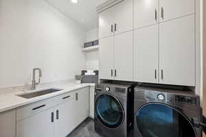 Laundry room featuring cabinet space, separate washer and dryer, and recessed lighting