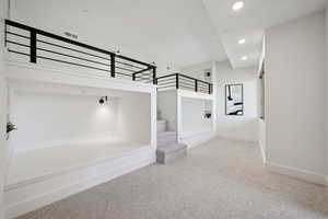 Stairs with recessed lighting, carpet, and baseboards