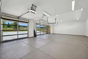 Garage featuring baseboards and a garage door opener