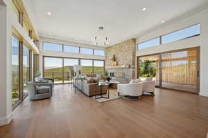 Living room featuring plenty of natural light, a fireplace, hardwood / wood-style floors, and recessed lighting