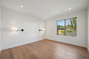 Unfurnished room with baseboards, recessed lighting, and hardwood / wood-style flooring