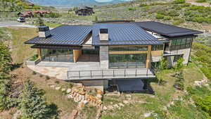 Aerial view of property and surrounding area featuring mountains