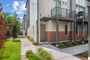 View of home's exterior featuring brick siding and a balcony