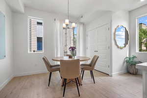 Dining room featuring a chandelier and light wood-type flooring