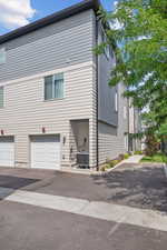 View of home's exterior with a garage and driveway