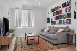 Living room with recessed lighting and wood finished floors