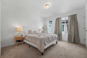 Carpeted bedroom featuring baseboards
