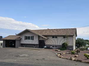 Split foyer home featuring an attached garage and brick siding