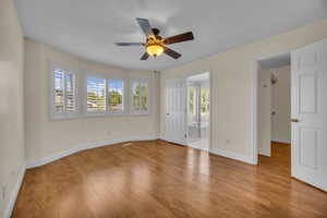 Unfurnished room with a ceiling fan and wood finished floors