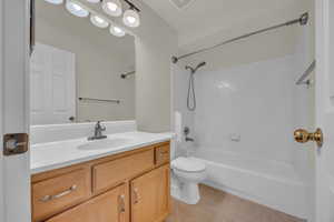 Full bath with tile patterned flooring,  shower combination, and vanity