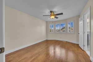 Unfurnished bedroom with light wood finished floors and ceiling fan