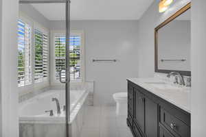 Full bathroom featuring vanity, a garden tub, and tile patterned floors