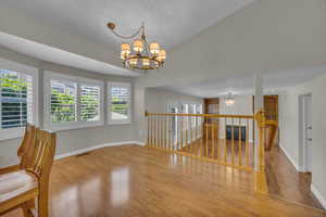 Unfurnished room with a chandelier and wood finished floors