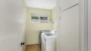 Washroom with washer and clothes dryer