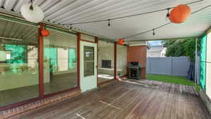 Wooden deck featuring a grill