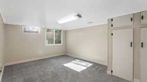 Carpeted empty room with baseboards