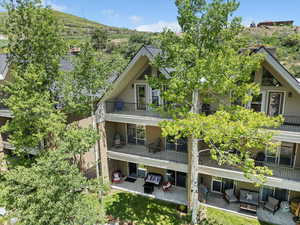 Rear view of house with outdoor lounge area, a patio, and a balcony