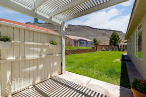 View of yard with a mountain view and a pergola