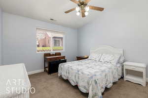 Bedroom featuring carpet floors, baseboards, a ceiling fan, and vaulted ceiling