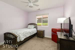 Carpeted bedroom featuring baseboards and ceiling fan