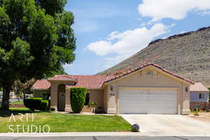 Mediterranean / spanish-style home featuring concrete driveway, stucco siding, an attached garage, a front lawn, and a tile roof
