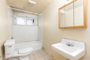 Bathroom featuring  shower combination and light tile patterned floors