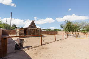 Fenced backyard with an outbuilding