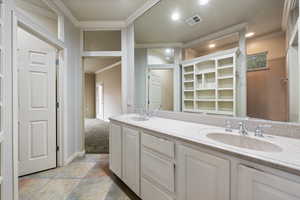 Full bathroom with crown molding, double vanity, recessed lighting, a closet, and tile patterned floors