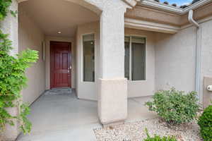 Entrance to property featuring stucco siding