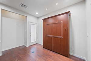 Entrance foyer with wood finished floors and recessed lighting