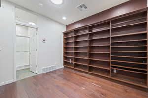 Unfurnished room featuring wood finished floors, recessed lighting, and a smoke detector