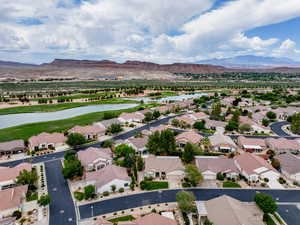 Aerial view of residential area with a water and mountain view and a local golf course