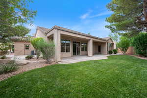 Rear view of house featuring stucco siding, a patio area, and a tile roof