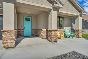 Entrance to property with stone siding and stucco siding