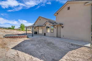 Back of house featuring a patio area and stucco siding