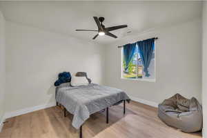 Bedroom with wood finished floors and ceiling fan