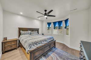 Bedroom with light wood-style flooring, recessed lighting, and ceiling fan