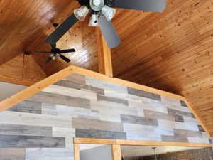 Detailed view of a ceiling fan, wooden ceiling, and wood walls
