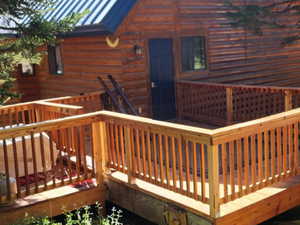 Back of house featuring a standing seam roof, a deck, and a metal roof