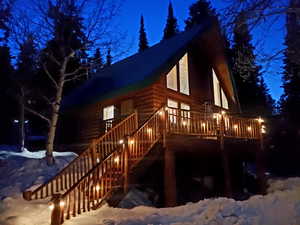 Snow covered property featuring stairway and a deck