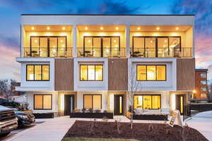 View of front of property featuring a balcony and outdoor lounge area