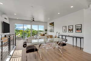 Dining area featuring light wood-type flooring, recessed lighting, a ceiling fan, and a wall unit AC
