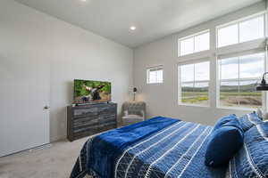 Primary bedroom with large windows and unobstructed views of east mountains