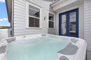 View of patio featuring a hot tub and french doors