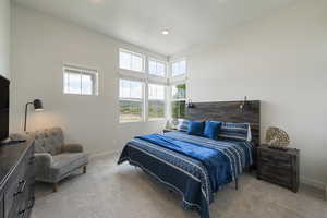 Primary bedroom with large windows and unobstructed views of east mountains