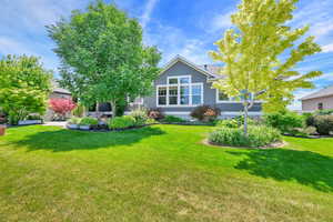 Rear view of property featuring a yard