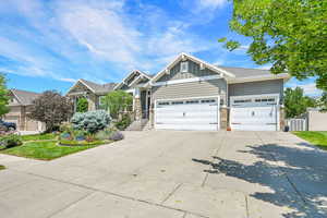 Craftsman inspired home with stone siding, board and batten siding, concrete driveway, and a garage